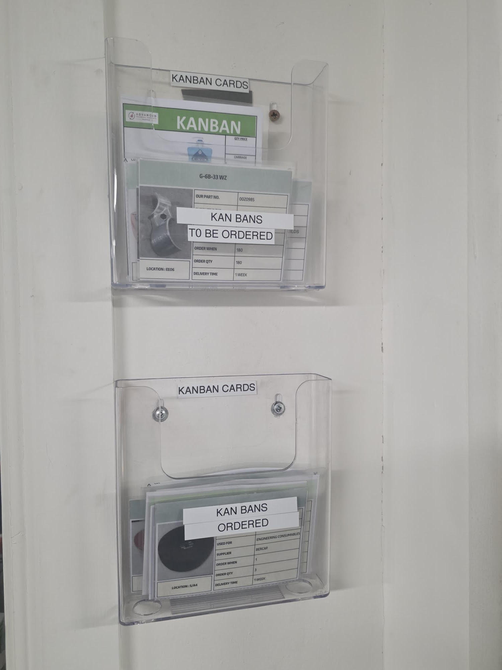 A4 document holder mounted on a Gemba board in a manufacturing facility