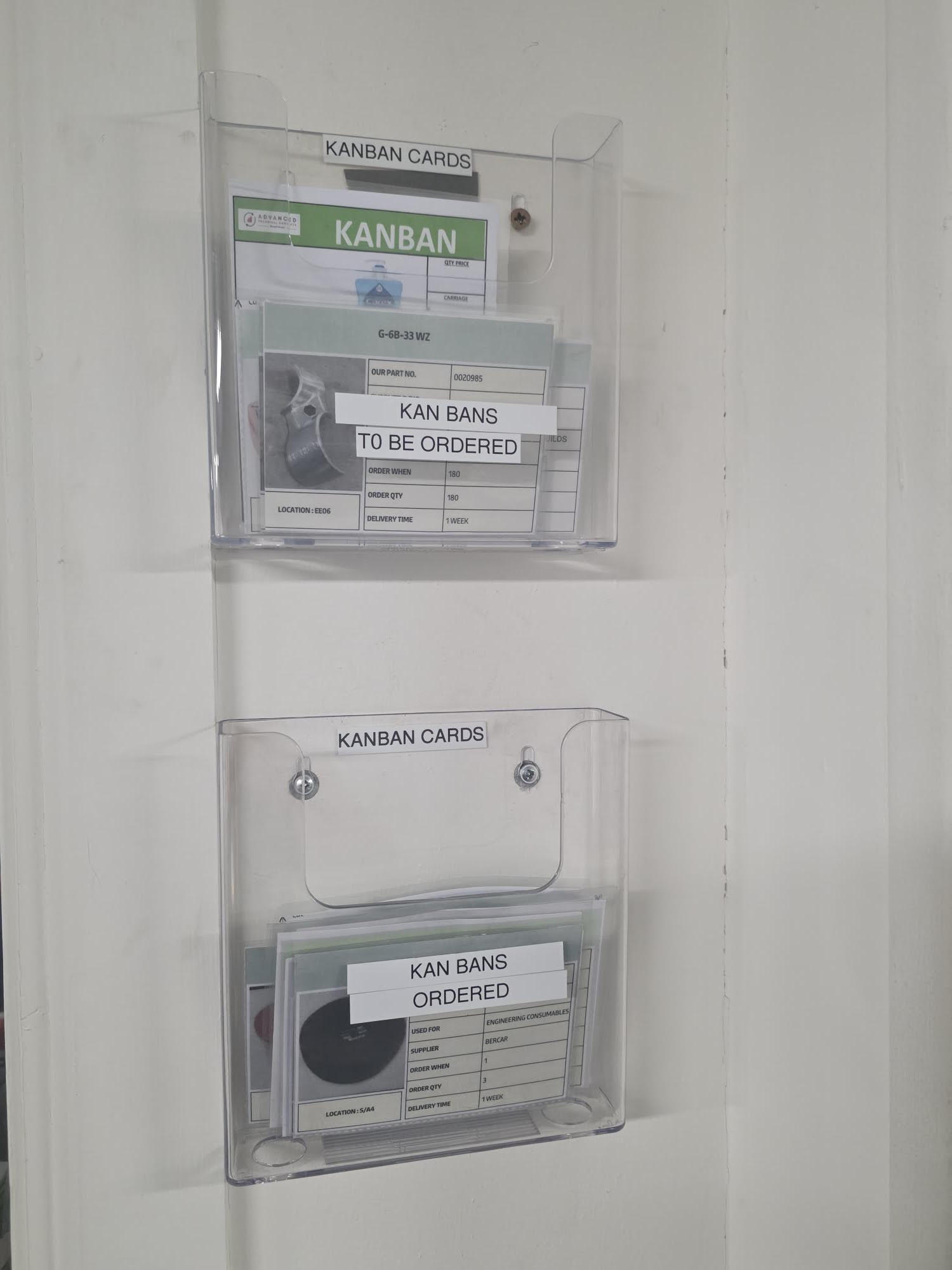 A4 document holder mounted on a Gemba board in a manufacturing facility