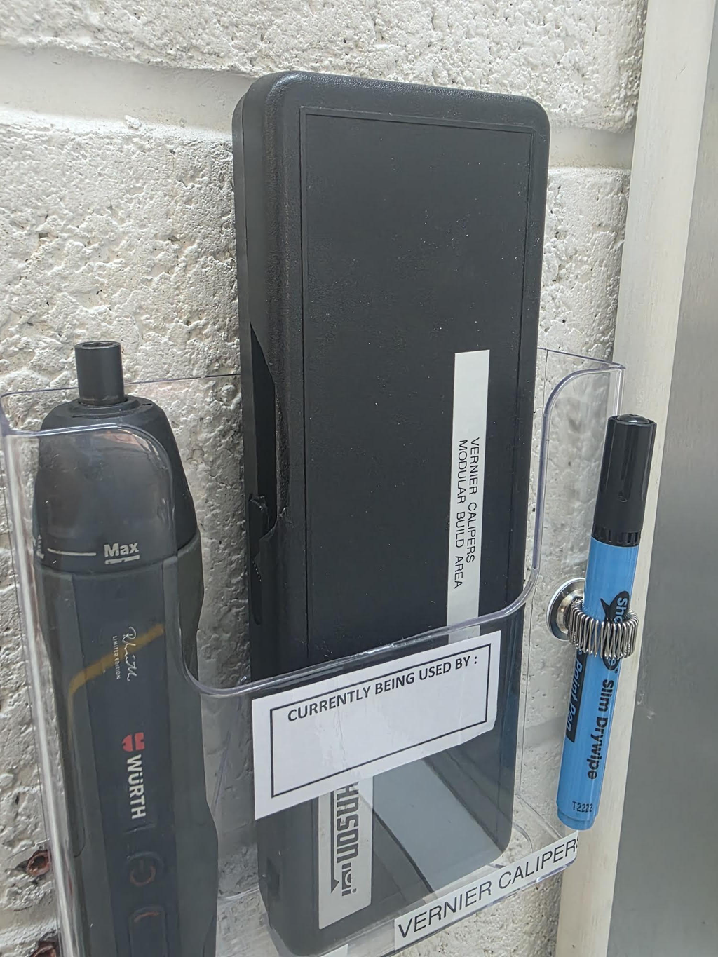 A5 document holder mounted at a workstation holding a tool tracking tag